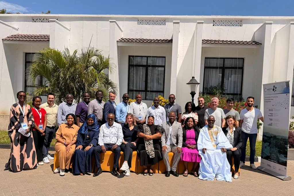Group photo of participants in front of the conference building