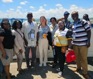 Nine people are standing on a terrace in the harbour area of Mombasa.
