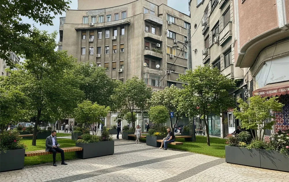 The same building, but now there is a park with benches in front of it where people can sit and relax.